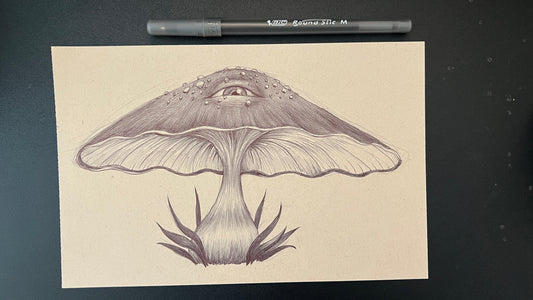 Detailed illustration of a mushroom on a beige card with a pen on a black background